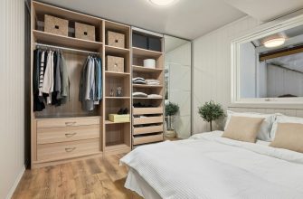 A bedroom with a bed, mirror and closet
