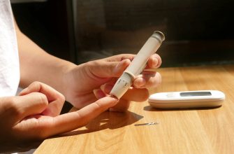a person sitting at a table with a cell phone